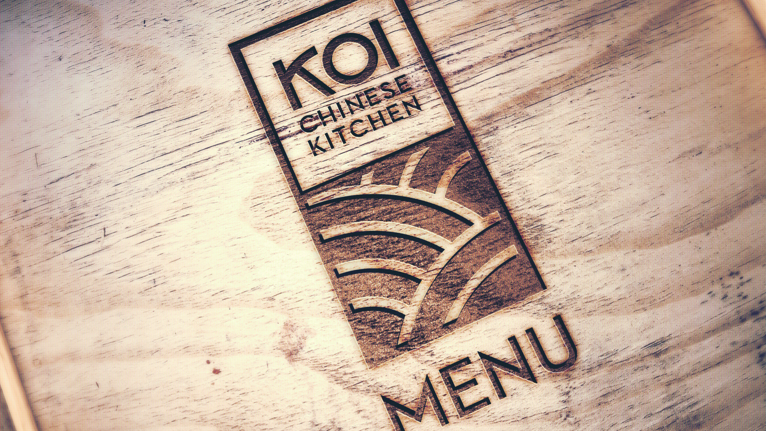 Image of Koi Kitchen wooden engraved menu design with Logo