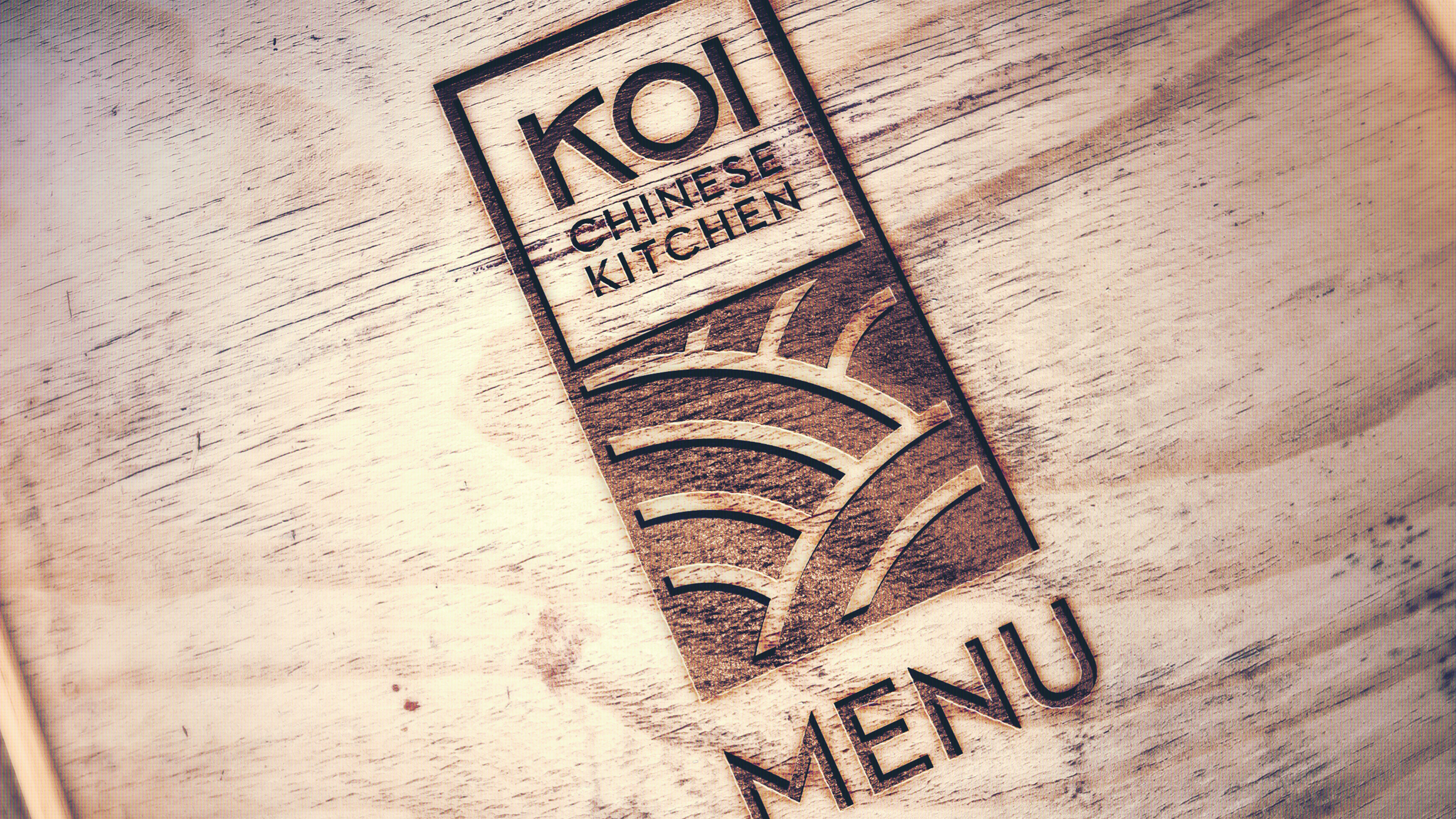 Image of Koi Kitchen wooden engraved menu design with Logo