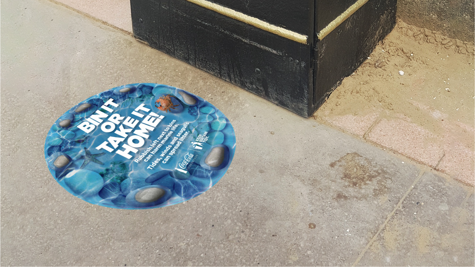 Marine littering floor sticker next to an outside bin